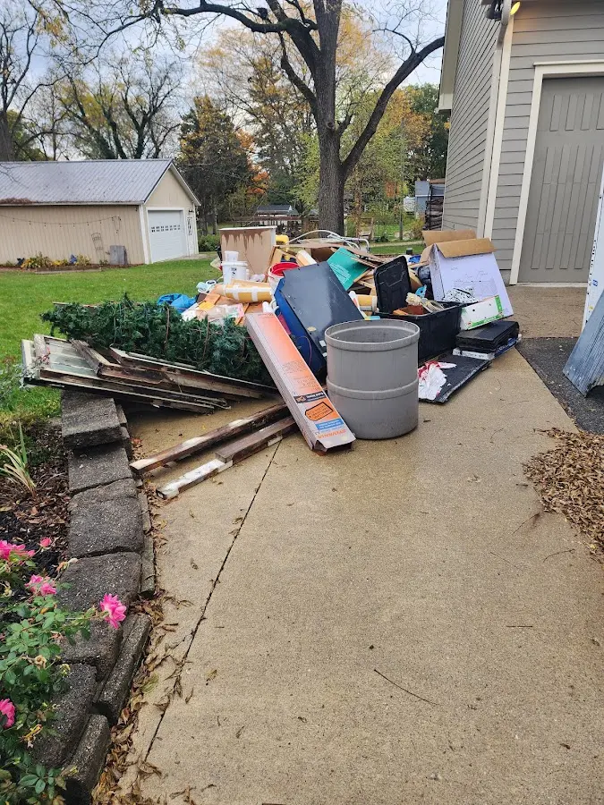 Dumpster being loaded with debris for Residential Dumpster Rental in Jasper